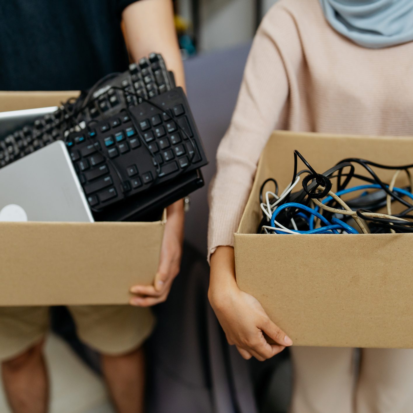 Image of a group of multiracial asian people carrying boxes of computer parts and cables for recycle. Asian people recycling electronic waste.